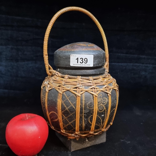 139 - A vintage Thai bamboo rattan basket / rice container with lid and handle.