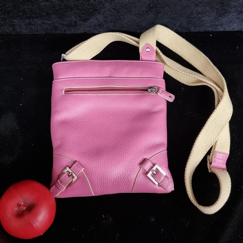 277 - A Jane Shilton genuine leather small crossbody messenger bag. Pink leather with a cream strap. In ve... 