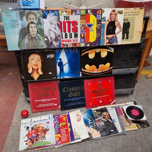 284 - A box containing an assortment of vinyl records and some 7'' singles including artists such as Walt ... 