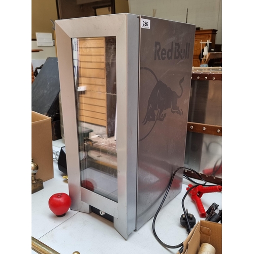 286 - A compact Red Bull mini fridge in working condition.