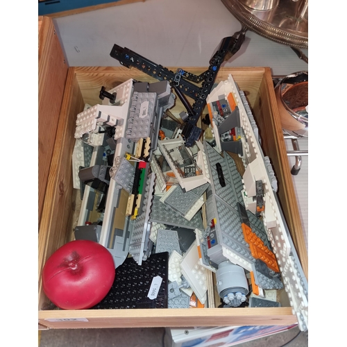 302 - A wooden box containing space themed Lego pieces.