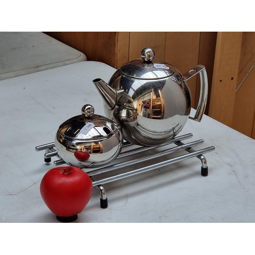 305 - A contemporary Bauhaus style teapot with matching sugar bowl in a chrome finish. Also includes metal... 