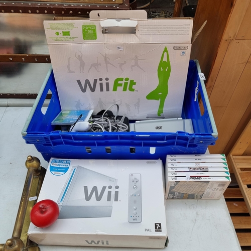 327 - A large blue crate comprising of a Wii console, Wii Fit board, cables, Wii games (Wii Play, Just Dan... 