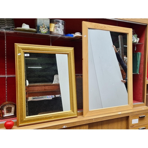 329 - Two modern mirrors including a large pine frame example and a smaller gilt gold frame example