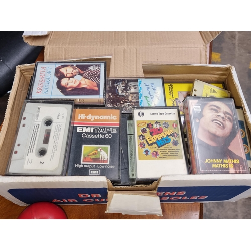 341 - A box containing a mixed assortment of vintage cassette tapes.