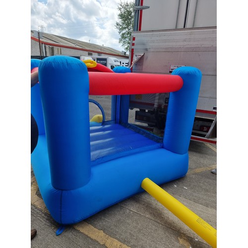 841 - A cheerful Happy Hop children's bouncy castle with slide, mesh sides and inclusive of air pump. Simi... 