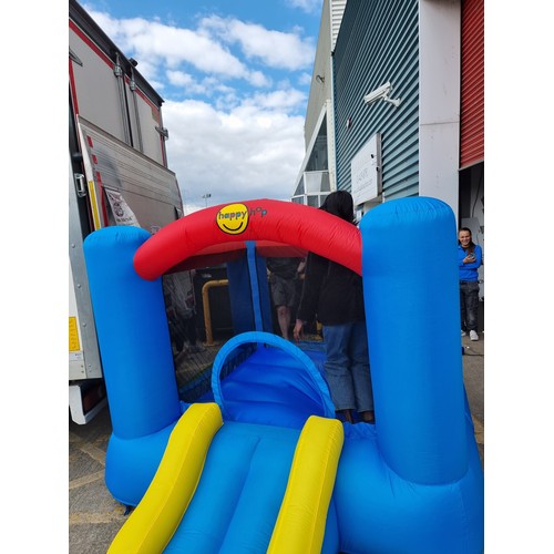 841 - A cheerful Happy Hop children's bouncy castle with slide, mesh sides and inclusive of air pump. Simi... 