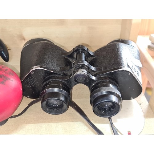 23 - A quality pair of Carl Zeiss 8 x 50 binoculars. Complete with neck strap. Slight scratch to lens.