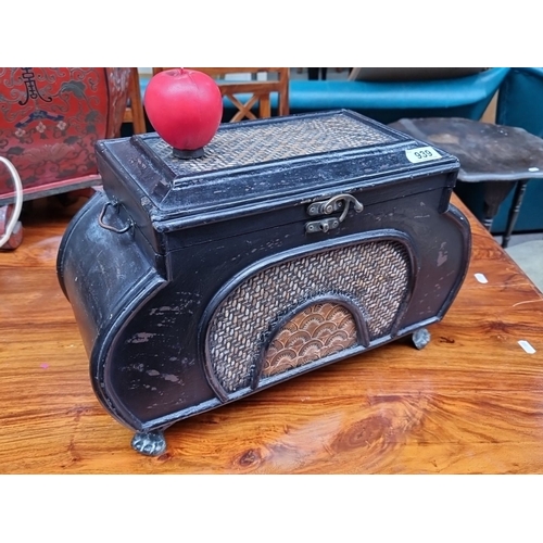 939 - A vintage black metal storage box with ornate wicker panels, decorative latch, and short claw feet. ... 