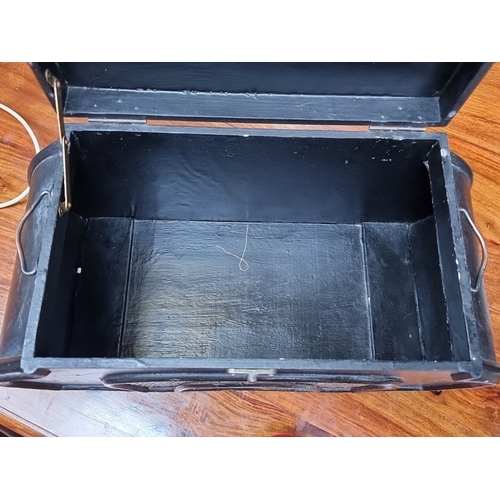 939 - A vintage black metal storage box with ornate wicker panels, decorative latch, and short claw feet. ... 