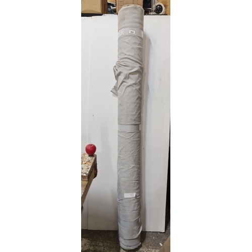 864 - A large roll of white fabric for furniture reupholstery.