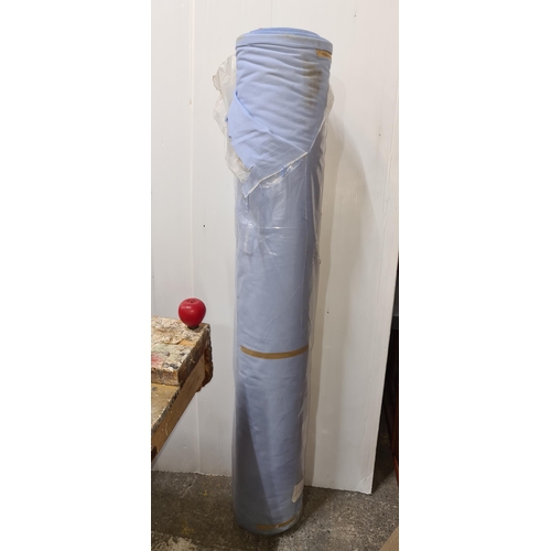 866 - A large roll of light blue fabric for furniture reupholstery.