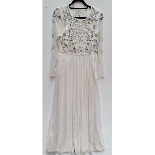 893 - A new with tags beautiful bridal or white party dress. New with tags. Size 12 and RRP of €110.00. Be... 