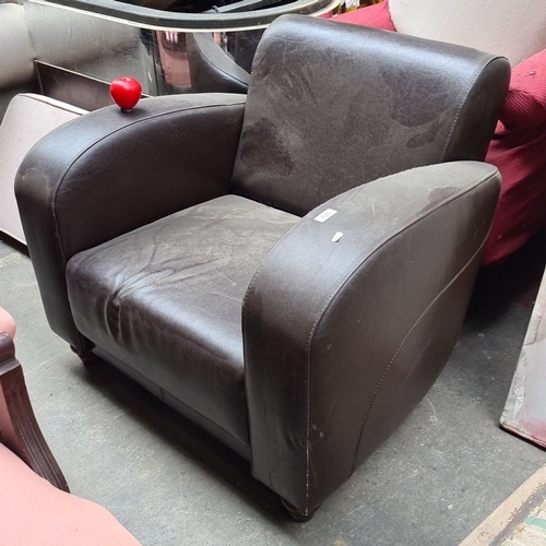 972 - Brown leather armchair with curved armrests and backrest, featuring sturdy construction and a classi... 