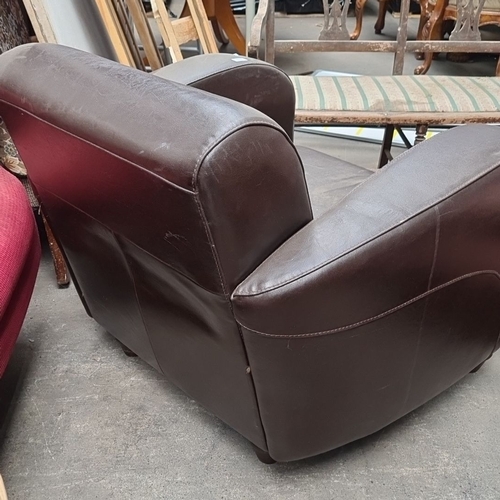 972 - Brown leather armchair with curved armrests and backrest, featuring sturdy construction and a classi... 