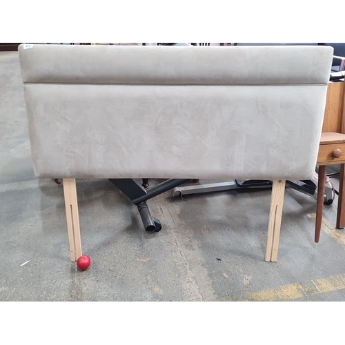 975 - A new Upholstered beige headboard with wooden legs.