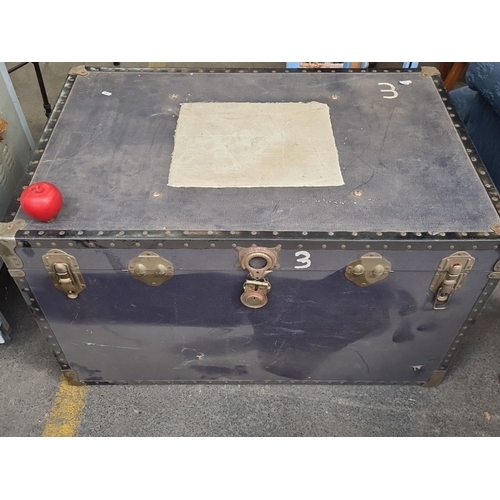 981 - A very large Vintage travel trunk with brass hardware and reinforced corners. Interior lined with bl... 