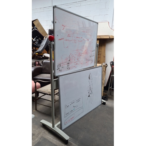 987 - Pair of mobile double-sided whiteboards on wheels. Brand: Nobo. Ideal for office or classroom use.