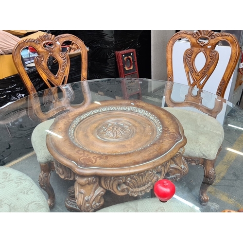 988 - Star lot...Round glass-top dining table with carved wooden base and four upholstered chairs. Elegant... 