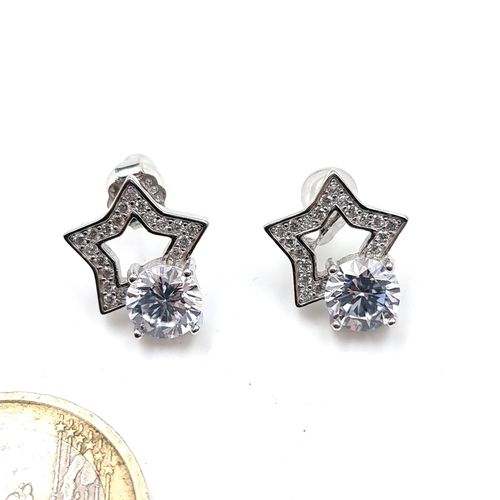 907 - A pair of star shaped earrings featuring moissanite gemstones 925 silver backs.