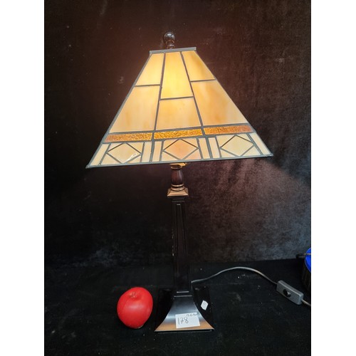 178 - A gorgeous clean example of a Tiffany style lamp, features a geometric shade and a tapered column.