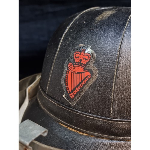 170 - An original 1960s RUC Riot helmet, With Irish harp, cap badge and face shield.
