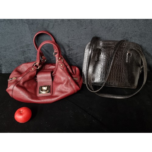 957 - A stunning DKNY wine coloured 100% genuine leather ladies handbag with three main compartments and i... 