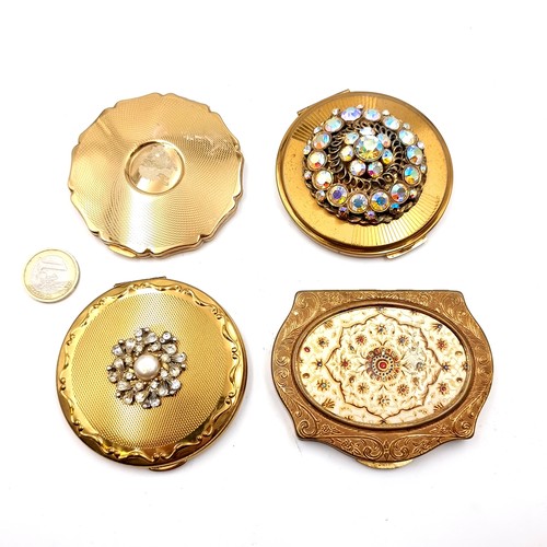 20 - A good collection of four vintage powder compacts set with enamelled and gem set detailing.(Includes... 