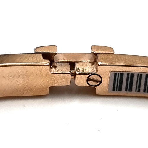 905 - A Hermes Clic H Bracelet. Features narrow bracelet in Rose Candeur enamel with gold plated hardware.... 