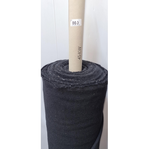 860 - A large roll of black fabric for furniture reupholstery.