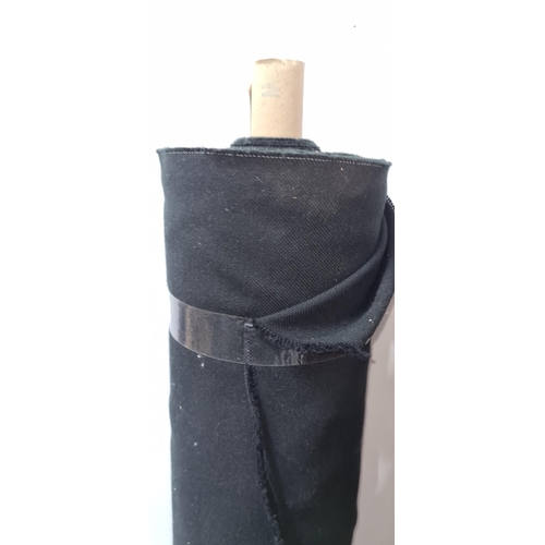 872 - A large roll of black fabric for furniture reupholstery.