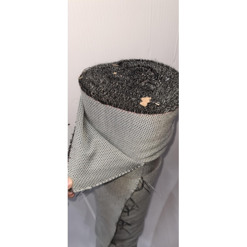 875 - A roll of grey fabric with black threads sewn throughout for furniture reupholstery.