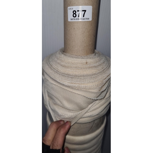 877 - A roll of beige mesh fabric for furniture reupholstery.