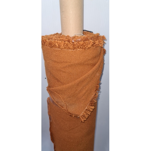 883 - A roll of burnt orange fabric for furniture reupholstery.