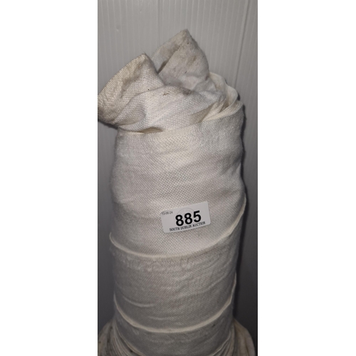 885 - A roll of white fabric for furniture reupholstery.