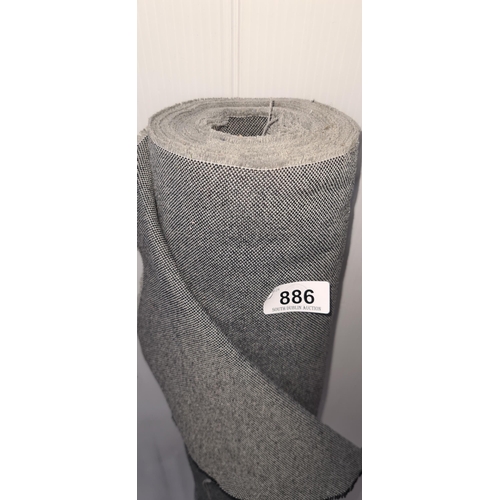 886 - A roll of fabric with black and grey threads sewn throughout for furniture reupholstery.