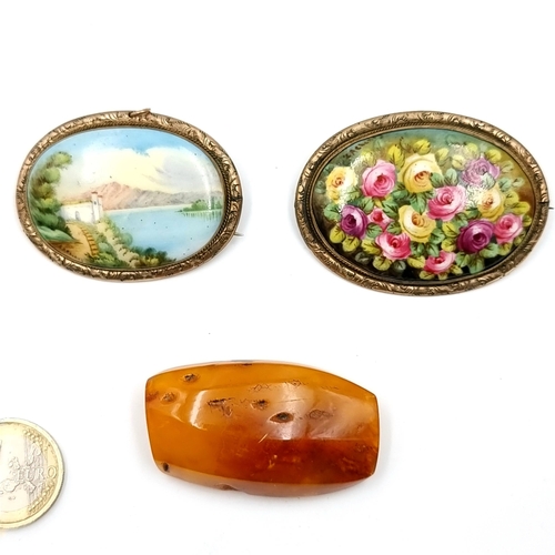 26 - Three vintage brooches. Two porcelain examples - one depicting a sea scene (could be used as a penda... 