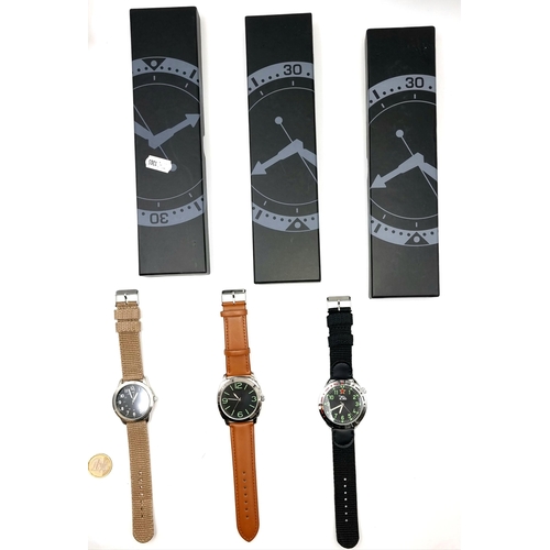 29 - A collection of three military watches. Together with warranty leaflets. In new condition. Old new s... 