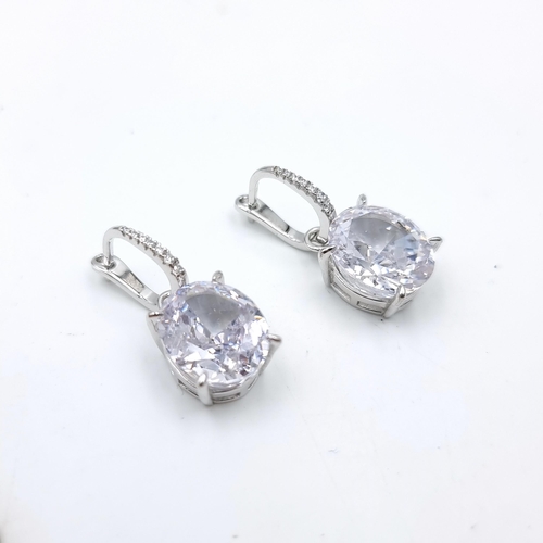 32 - A pair of lovely Sterling Silver drop pendant earrings, with diamond loops and large bright Moissani... 