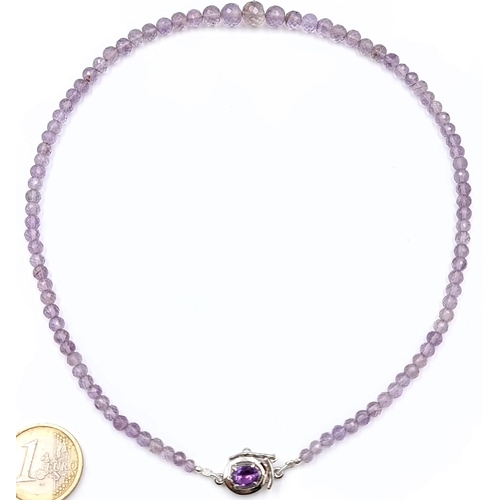 53 - An amethyst graduated stone necklace set with amethyst clasp mounted in sterling silver. Length - 42... 