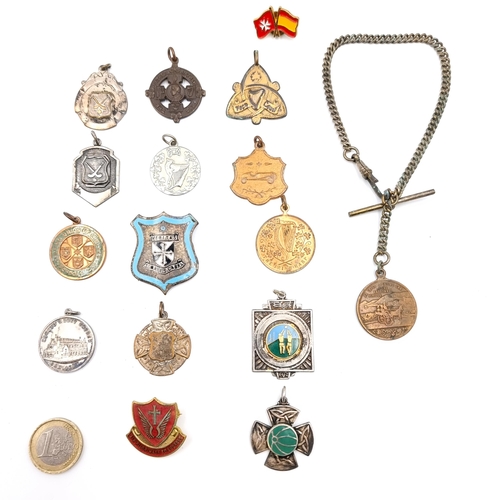 55 - A collection of medallions together with a fob and chain. Items as photographed.