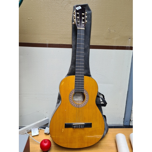 299 - An Encore acoustic guitar Model No ENC44 b y John Hornby Shewes & Co LTD. Missing one string, comes ... 