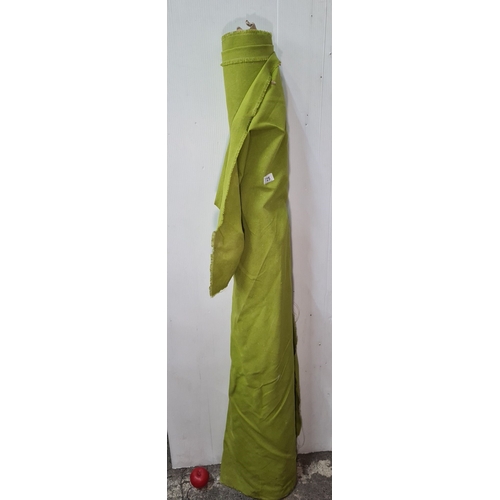 725 - A large roll of lime green fabric for furniture reupholstery.