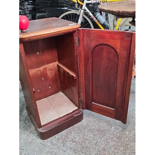 717 - A Victorian red mahogany  pot cupboard with a paneled door. Classic design.