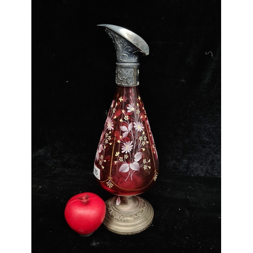 185 - A gorgeous vintage cranberry glass claret jug featuring hand painted floral decoration. Missing hand... 