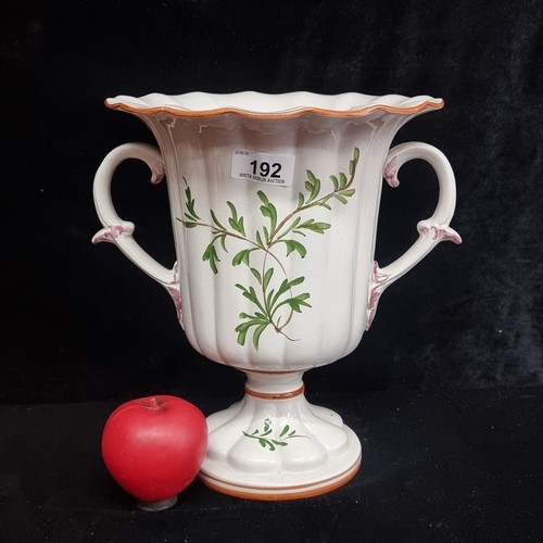 192 - A very pretty hand painted urn shaped vase. Signed to base. In good order