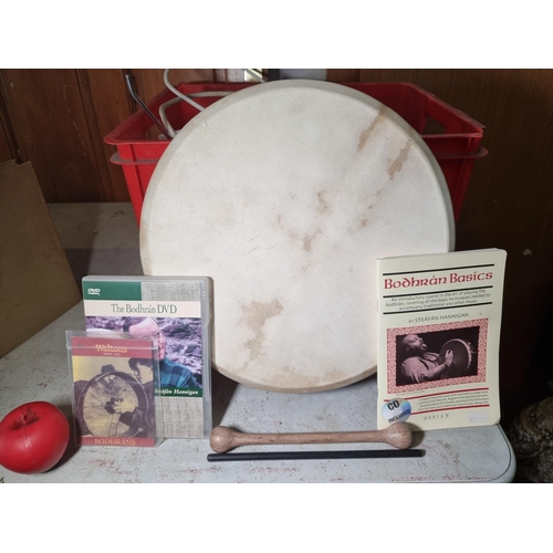 1182 - A bodhrán sold by Waltons with original tags, beater, instruction booklet and two learner DVDs. Incl... 