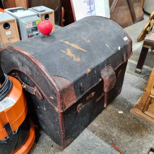 1209 - A large 19th century leather trunk with striped lining.