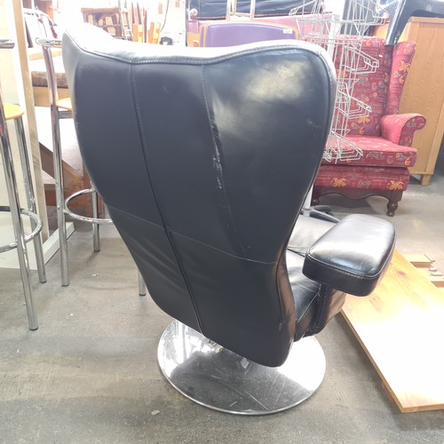 715 - Star Lot : A fabulous vintage Danish Verikon black leather swivel chair with padded armrests and chr... 