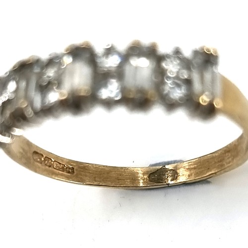 15 - A nine carat gold gem set half eternity ring. Ring size - N. Weight - 1.77 grams.